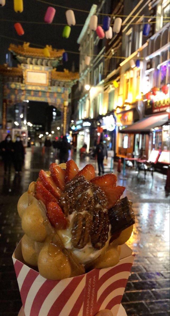 a basket filled with lots of food sitting on top of a table next to a building