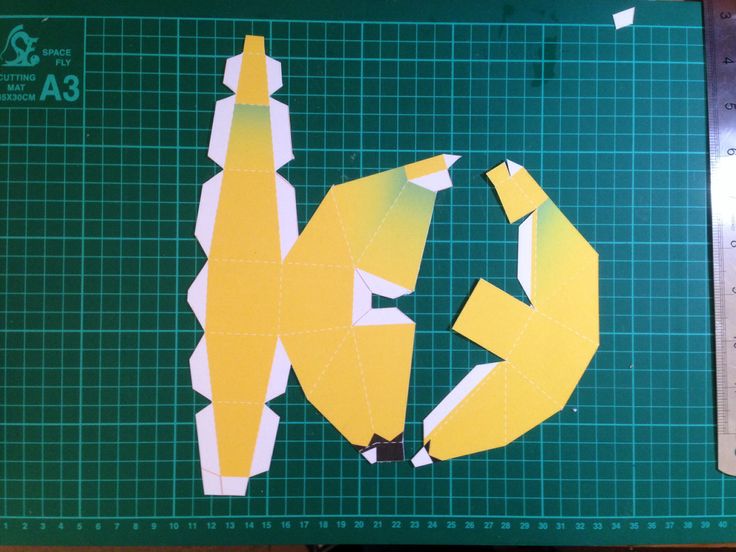 cut out pieces of paper sitting on top of a cutting mat