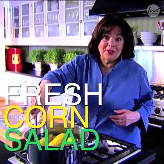 a woman standing in front of an oven with the words fresh corn salad on it