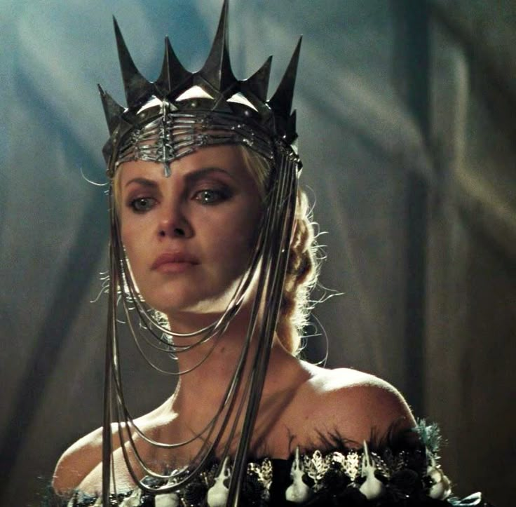 a woman wearing a crown and chain around her neck