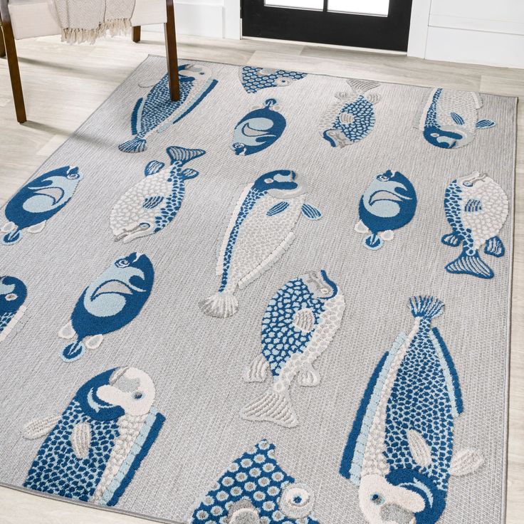 a blue and white rug with fish on it