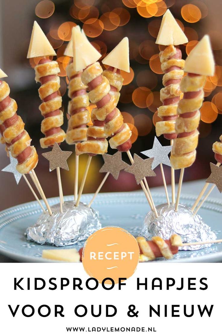 some candy sticks are on a plate with stars and silver foil wrapped around them, ready to be eaten