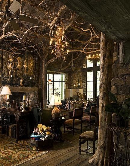 a living room filled with furniture and lots of trees growing out of the wall behind it