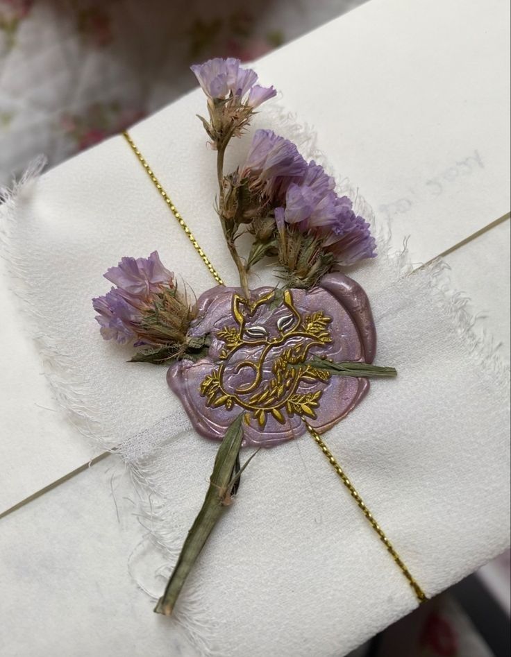 a piece of paper that has some flowers on it and is attached to a chain