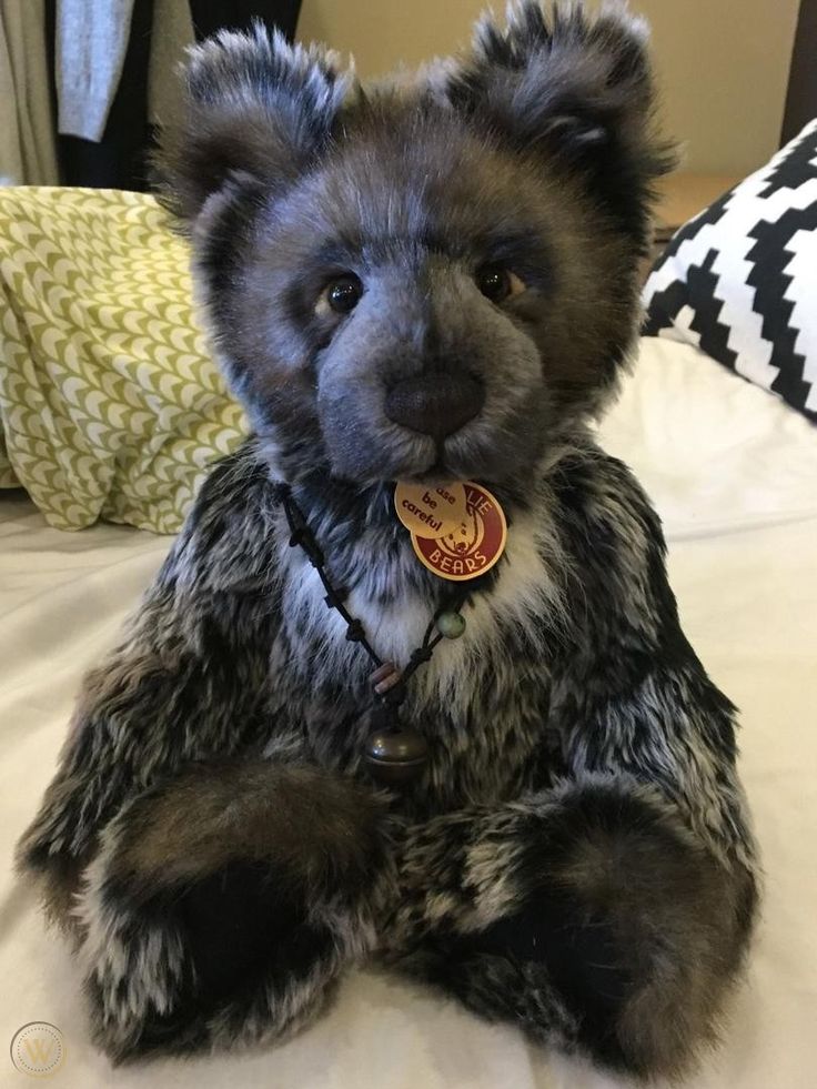 a teddy bear sitting on top of a bed