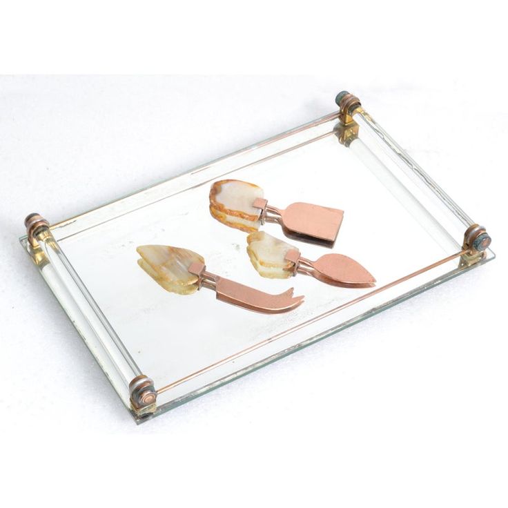 three pieces of metal and glass on a tray