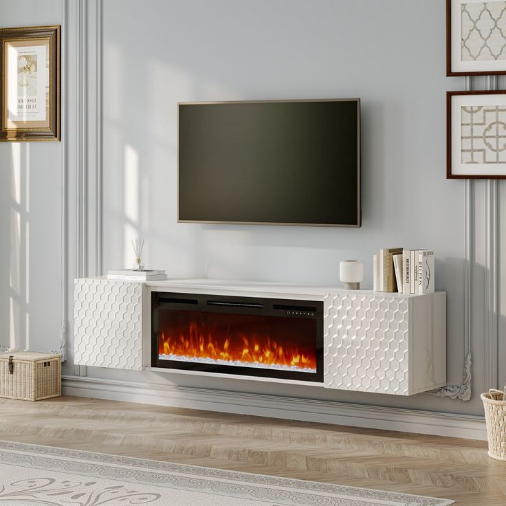 a living room with a television and fire place in the fireplace, it's all white