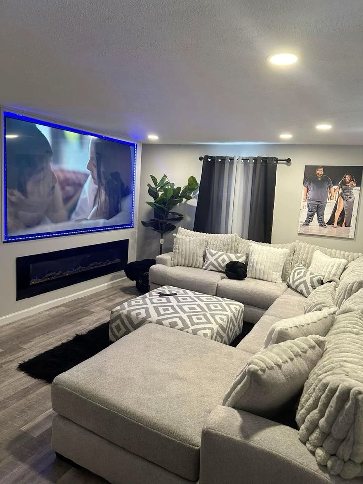 a living room filled with furniture and a flat screen tv mounted to the wall above it