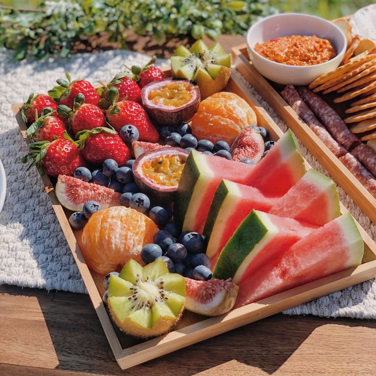 an assortment of fruits and crackers on a tray