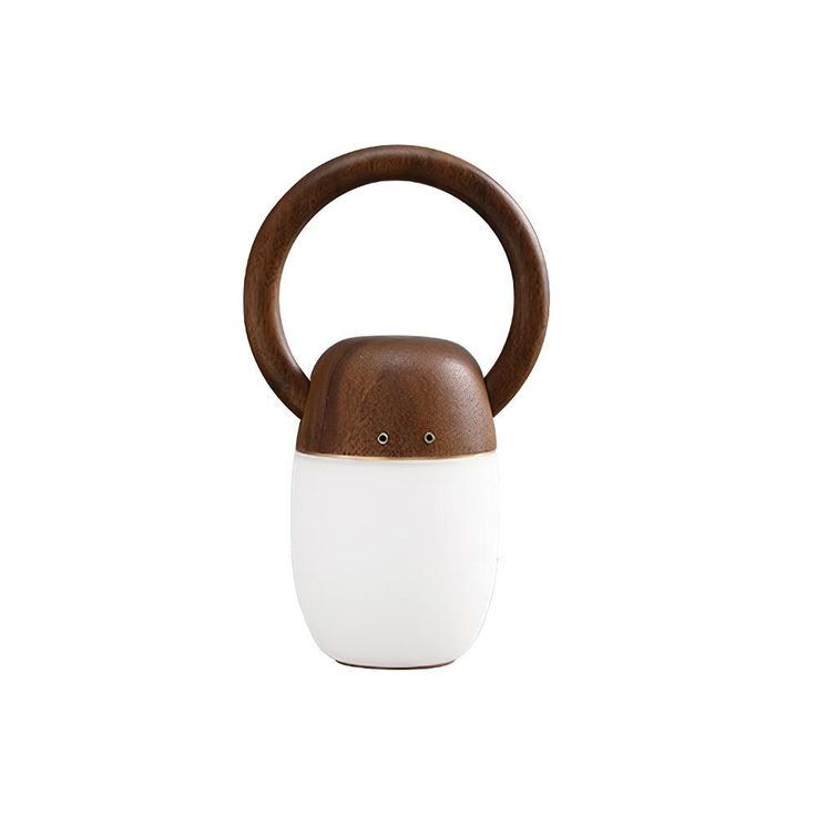 a wooden and white object on a white background with a brown handle that is shaped like an apple