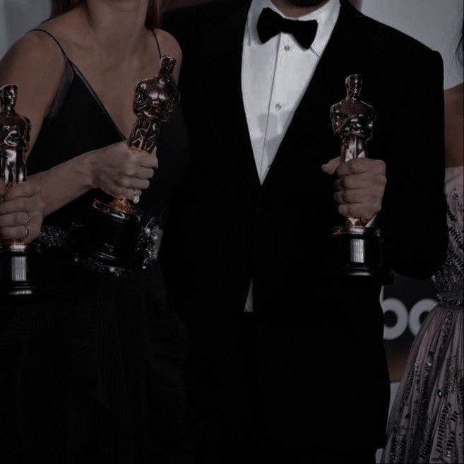 two people in tuxedos holding their oscars for best supporting actor and actress