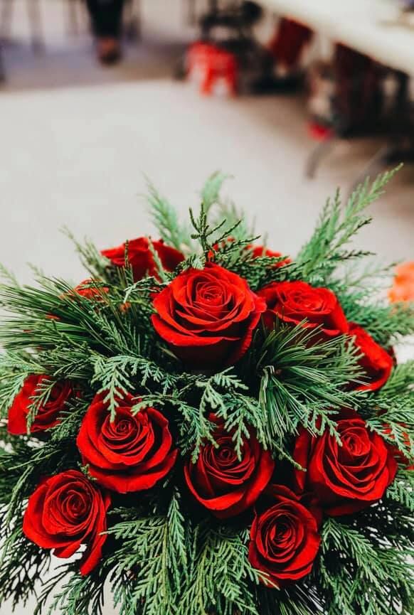 a bouquet of red roses sitting on top of a table