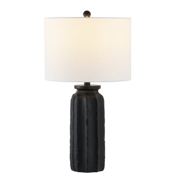 a black table lamp with a white shade on the base and a light in front of it