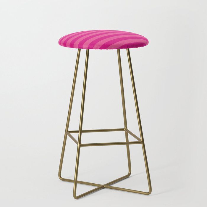 a pink and gold bar stool with a striped seat cushion on the bottom, in front of a white background