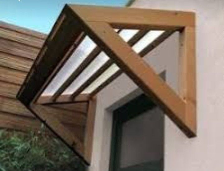 an open window on the side of a house with wood slats and white walls