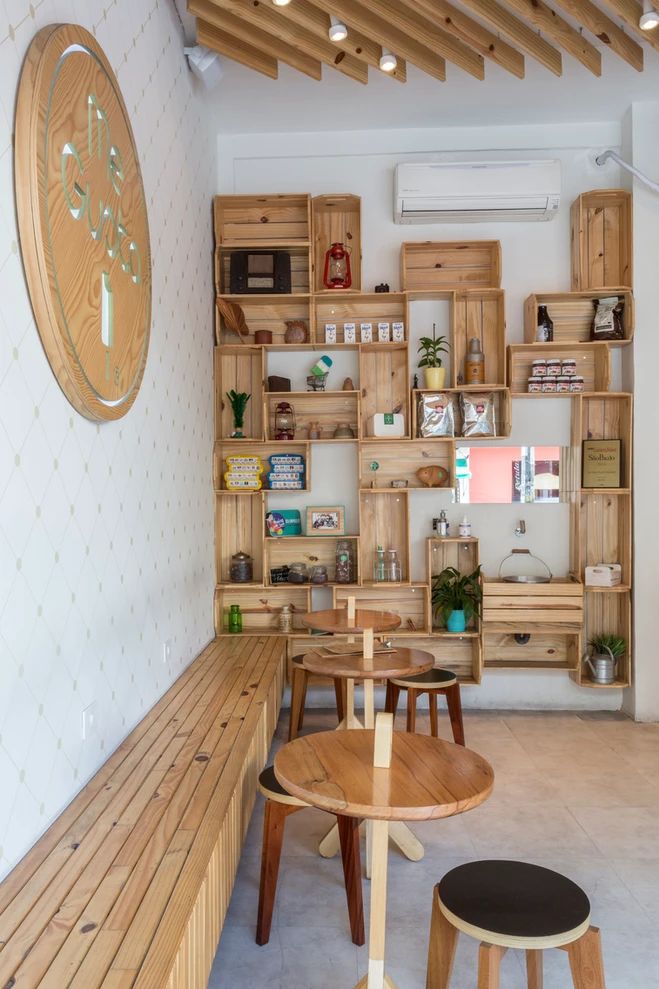 a wooden table sitting under a clock in a room