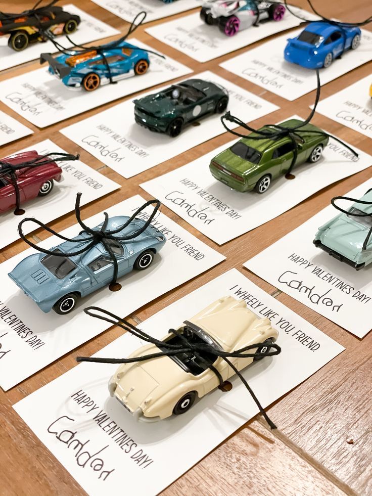 many toy cars are displayed on cards with words written in black and white ink,