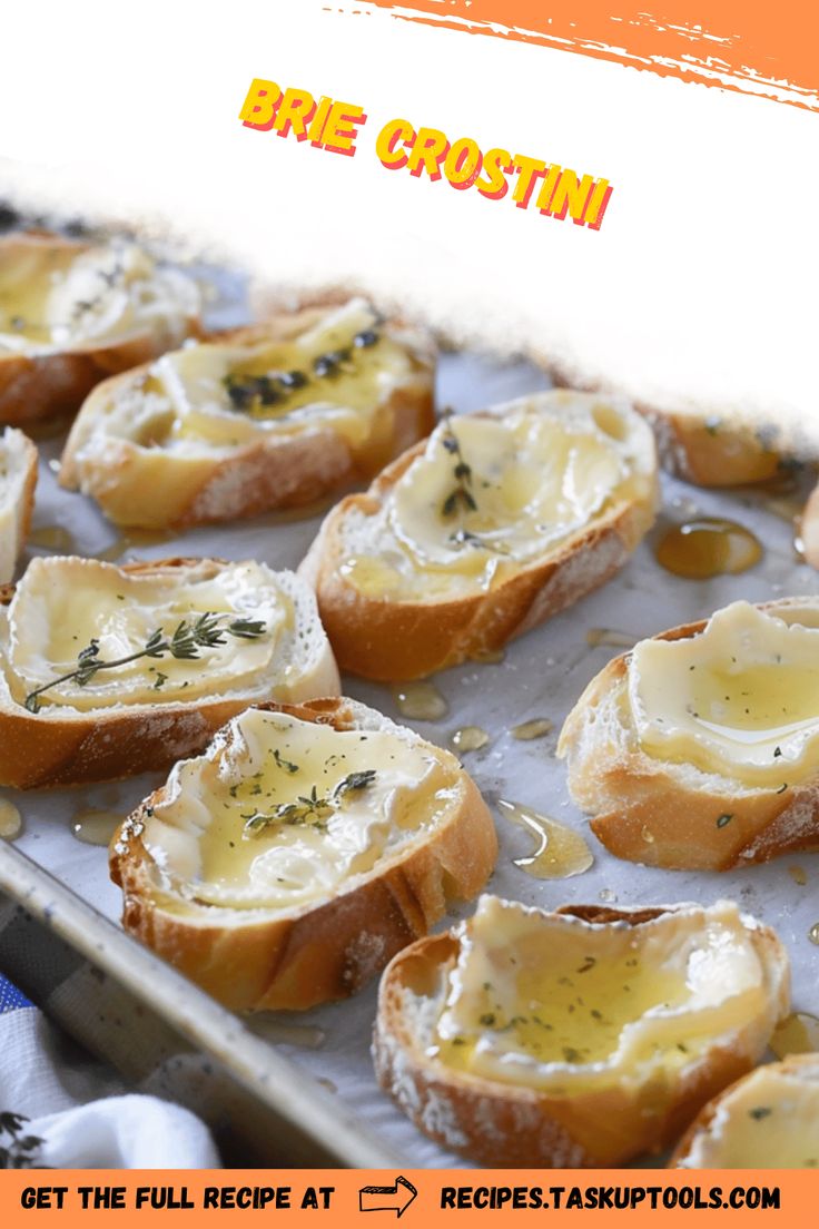 baked bread with cheese and herbs on it sitting on a baking sheet in front of an advertisement for brie crostini