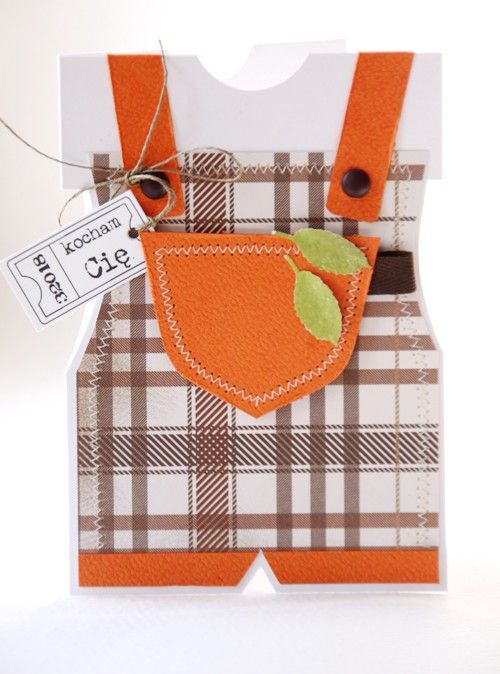 an orange bib and suspender is attached to a card