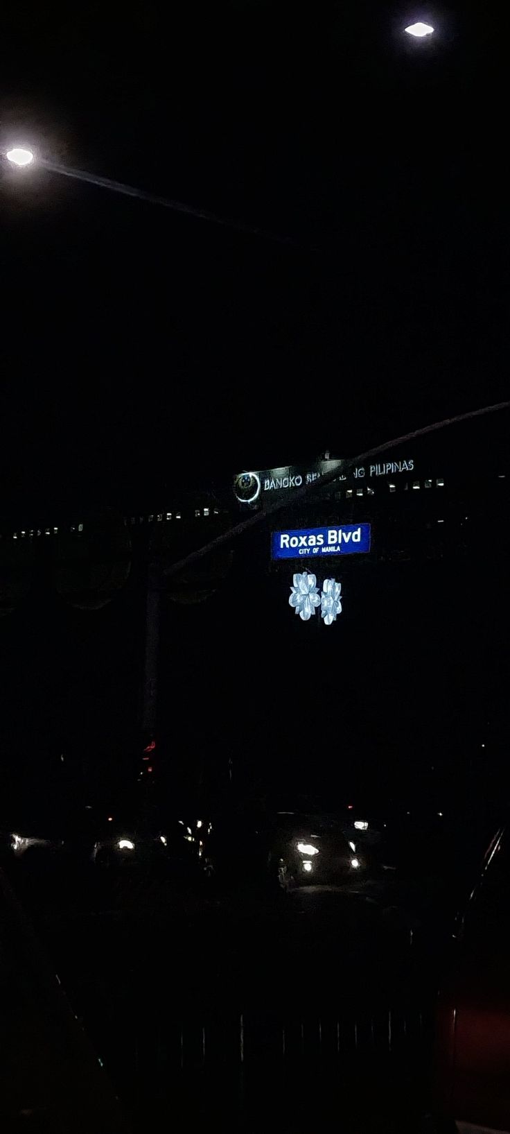 cars parked in the dark at night with lights on and signs above them that read rock'n'blvd