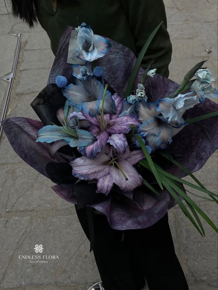 a woman holding a bouquet of flowers in her hands