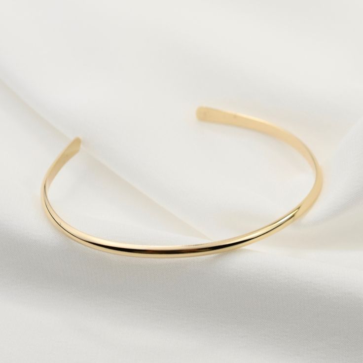 "14K gold cuff bracelet. 14K Gold Minimalist Cuff Bracelet, Delicate cuff bracelet. The bracelet will be shipped in a gift box * 14K solid gold. It is about 2.5mm width. Please select the size of your wrist. If your wrist is 6\", please purchase a 6\" bracelet. (If you order a 6\" bracelet, actual cuff length will be 5\" plus 1 inch opening.) Please read our policies before you place your order. https://www.etsy.com/shop/SashJewelry/policy?ref=shopinfo_policies_leftnav To see other Mother daught Gold Open Cuff Elegant Jewelry, Elegant Everyday Luxury Cuff Bangle Bracelet, Elegant Gold Open Cuff Jewelry, Elegant Open Cuff Bangle With Polished Finish, Modern Yellow Gold Bangle Cuff Bracelet, Timeless Gold Open Cuff Bracelet, Elegant Bangle With Polished Finish As Gift, Classic Gold Open Cuff Bracelet, Elegant Gold Bracelet With Open Band