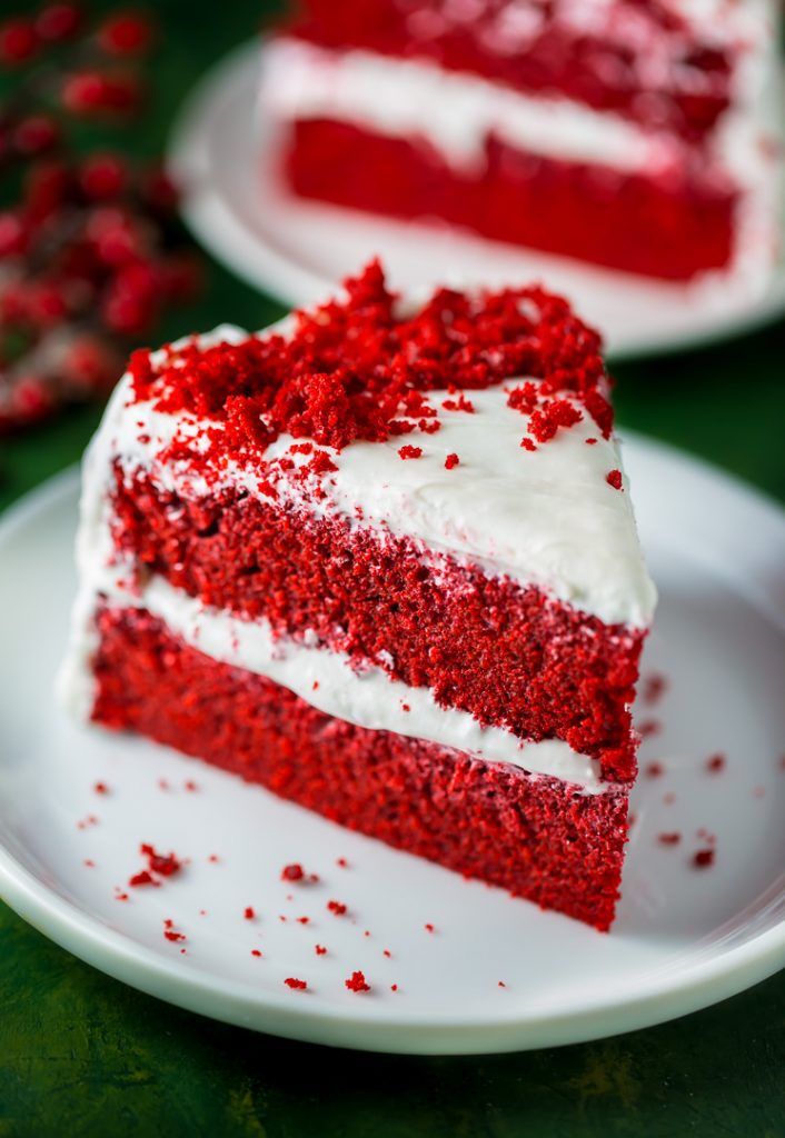 a slice of red velvet cake with white frosting