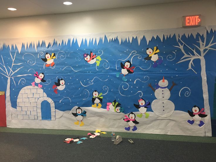 a bulletin board with snowmen and penguins on it in an office building, surrounded by confetti