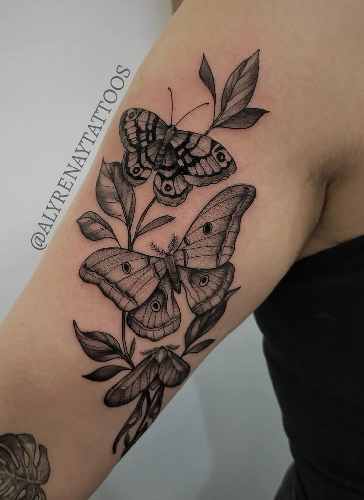 a woman's arm with butterflies on it and leaves around the arm, in black ink