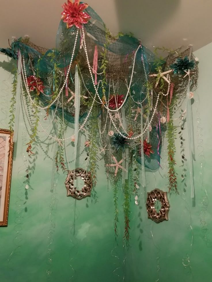 there are many decorations hanging from the ceiling in this room, including flowers and pearls