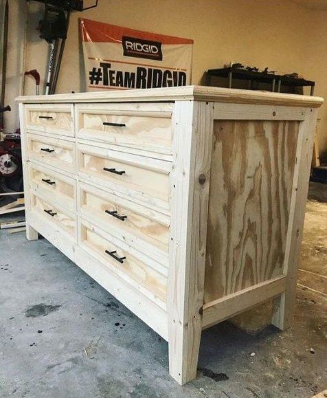 a large wooden dresser sitting inside of a garage