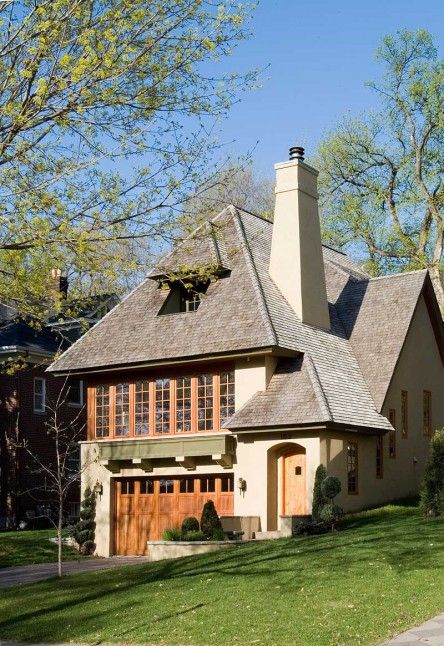 a large house with a lot of windows on the front and side of it's roof