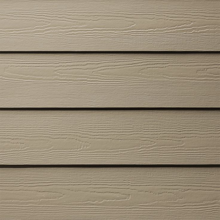 the side of a house with wood siding and white paint on it's walls