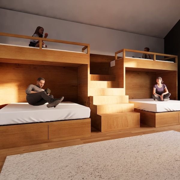 two people are sitting on bunk beds in a room with carpeted floor and walls