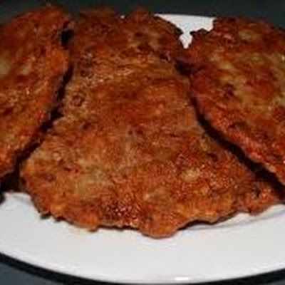 three pieces of fried food on a white plate