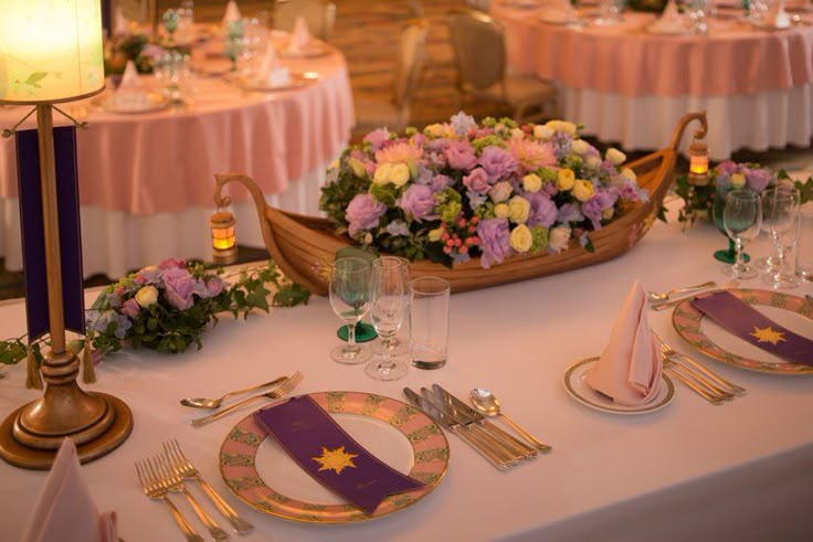 the table is set with flowers and place settings