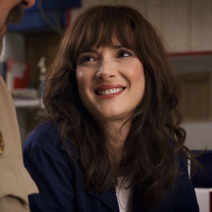 a woman in uniform talking to a man with his hand on her hip and smiling