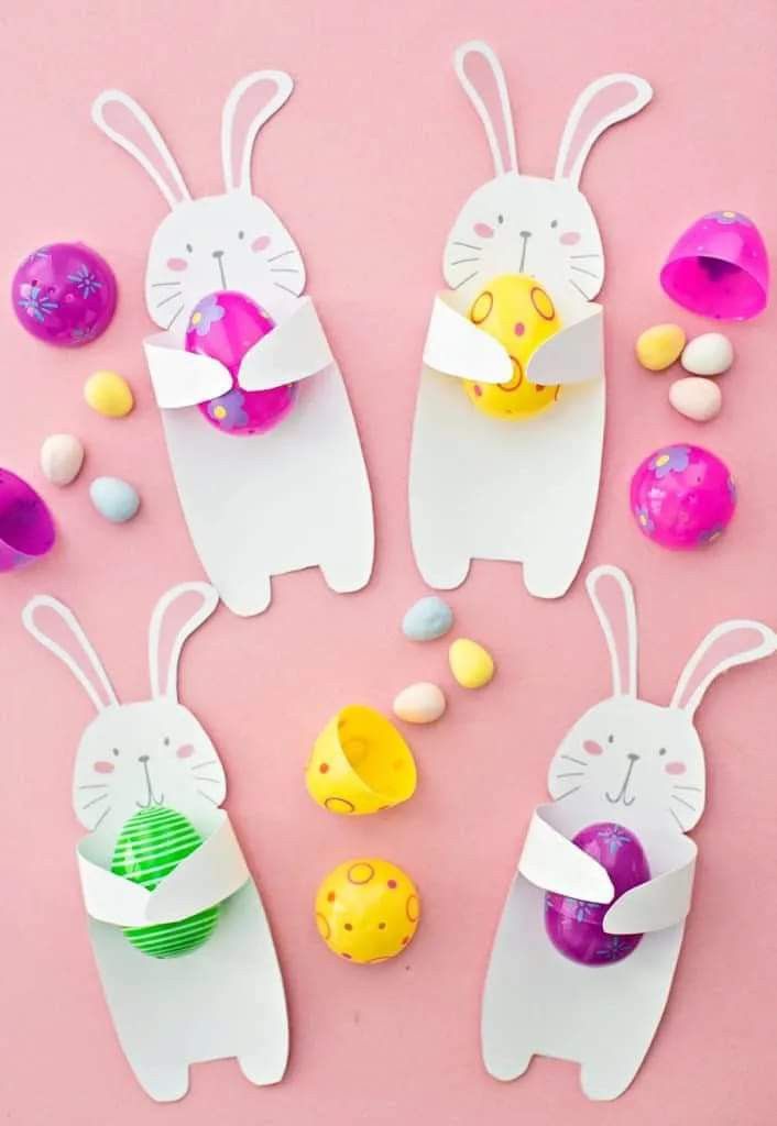 easter bunny paper craft for kids to make with eggs and other decorations on a pink background