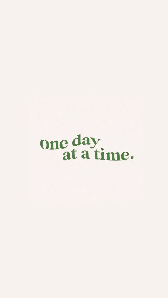 the words one day at a time are written in green ink on a white background