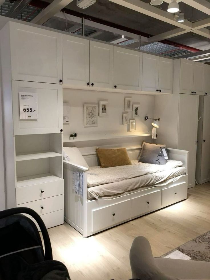 a white bed sitting in the middle of a room