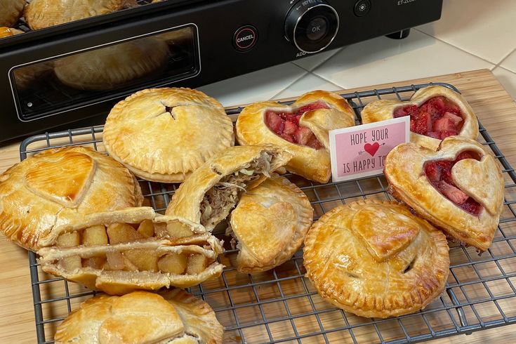 several pastries on a cooling rack next to a toaster oven