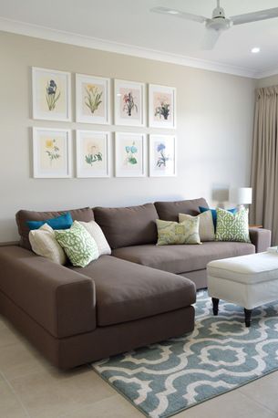 a living room filled with furniture and pictures on the wall above it's couch