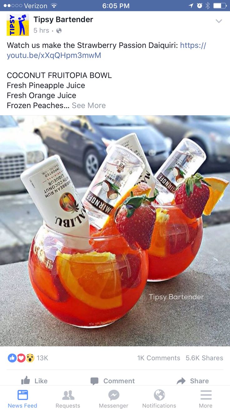 two glasses filled with fruit punch sitting next to each other on top of a table