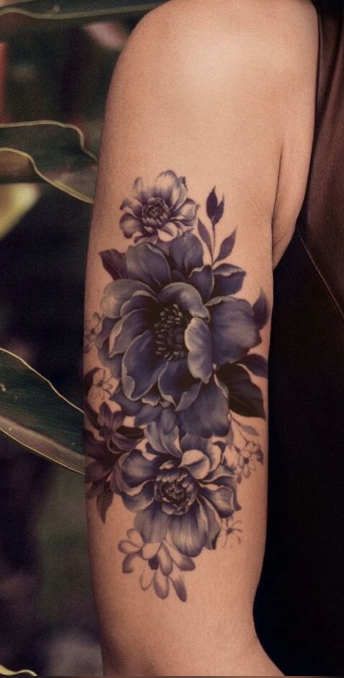 a woman with a flower tattoo on her arm