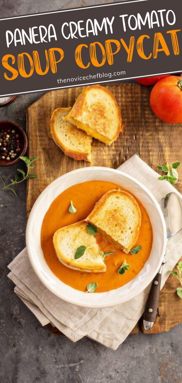 a white bowl filled with soup and toast on top of a wooden cutting board next to tomatoes