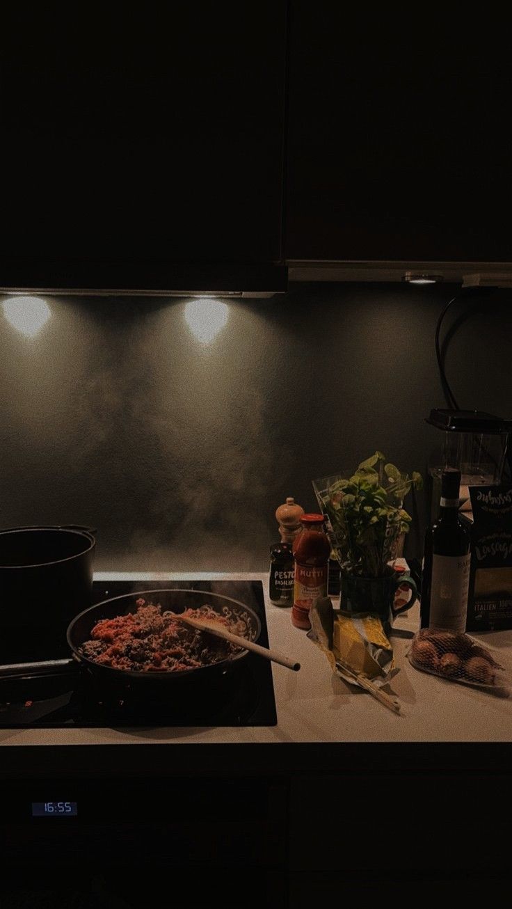 a stove top with food cooking on it in a kitchen next to a pot and pan