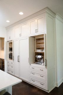 a kitchen with white cabinets and an island