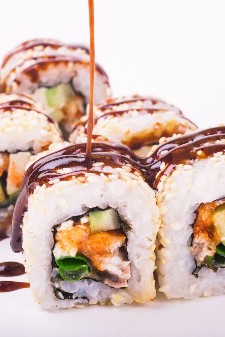 sushi rolls with sauce drizzled on top