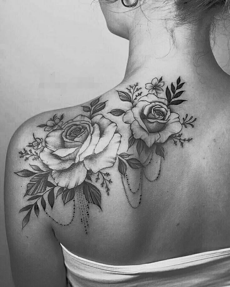 the back of a woman's neck with roses on it