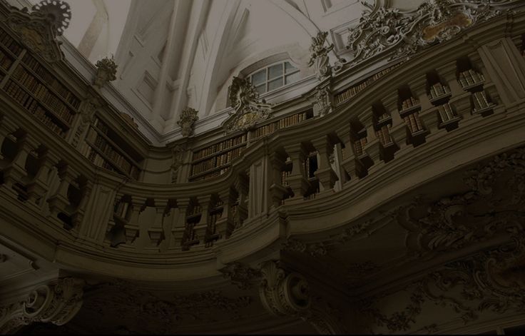 an ornate building with a clock tower in the center and many bookshelves below